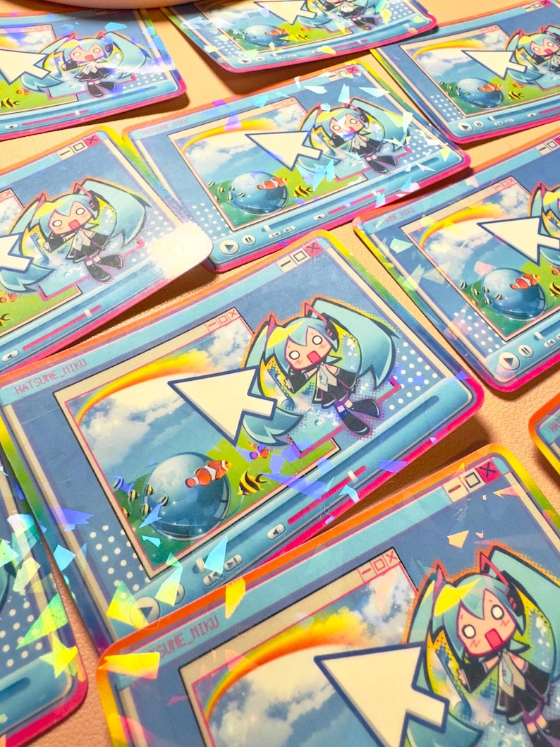 May include: A set of colorful stickers featuring a cartoon character with blue hair and a blue and white background. The stickers have a holographic finish and feature the text "Hatsune Miku".