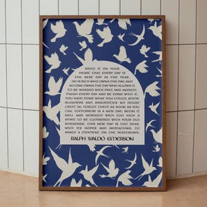 May include: A framed print with a blue background and white silhouettes of birds. The print features a quote by Ralph Waldo Emerson: "Write it on your heart that every day is the best day in the year."