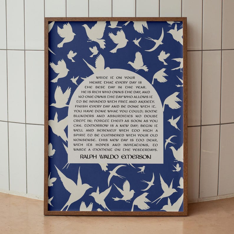 May include: A framed print with a blue background and white silhouettes of birds. The print features a quote by Ralph Waldo Emerson: "Write it on your heart that every day is the best day in the year."