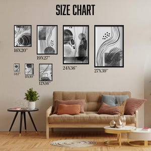 May include: A size chart for black and white abstract art prints. The chart shows the different sizes available, ranging from 5x7 inches to 27x39 inches. The prints are displayed on a wall above a brown couch with pillows.