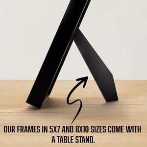 May include: A black picture frame with a built-in easel stand. The frame is designed to hold 5x7 or 8x10 inch photos.