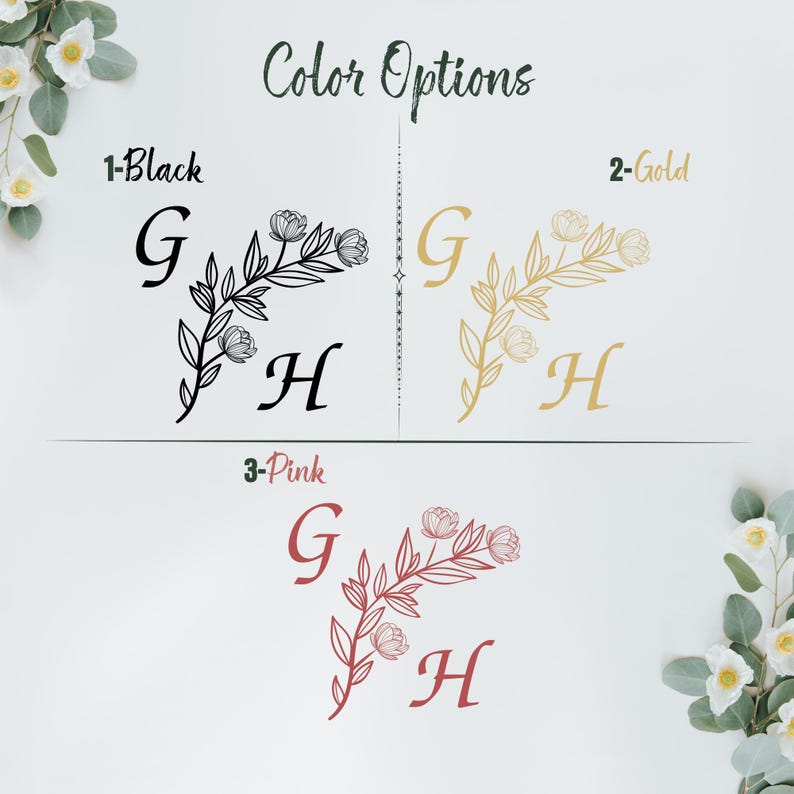 Op de afbeelding: Drie kleuropties voor een bloemig monogramontwerp. Het ontwerp bevat de letters "G" en "H" met een bloemtak en bladeren. De kleuropties zijn zwart, goud en roze.