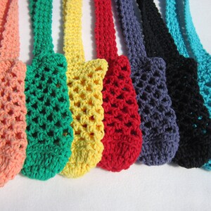 May include: Eight crocheted bags in various colors, including peach, green, yellow, red, gray, black, and turquoise. The bags are made with a simple mesh pattern and have a loop at the top for hanging.