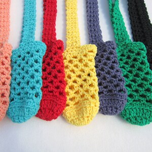 May include: A set of eight crocheted bottle holders in various colors, including peach, turquoise, red, yellow, gray, green, and black. The holders are made with a simple, open-weave pattern and have a loop at the top for hanging.