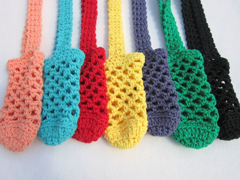 May include: A set of eight crocheted bottle holders in various colors, including peach, turquoise, red, yellow, gray, green, and black. The holders are made with a simple, open-weave pattern and have a loop at the top for hanging.