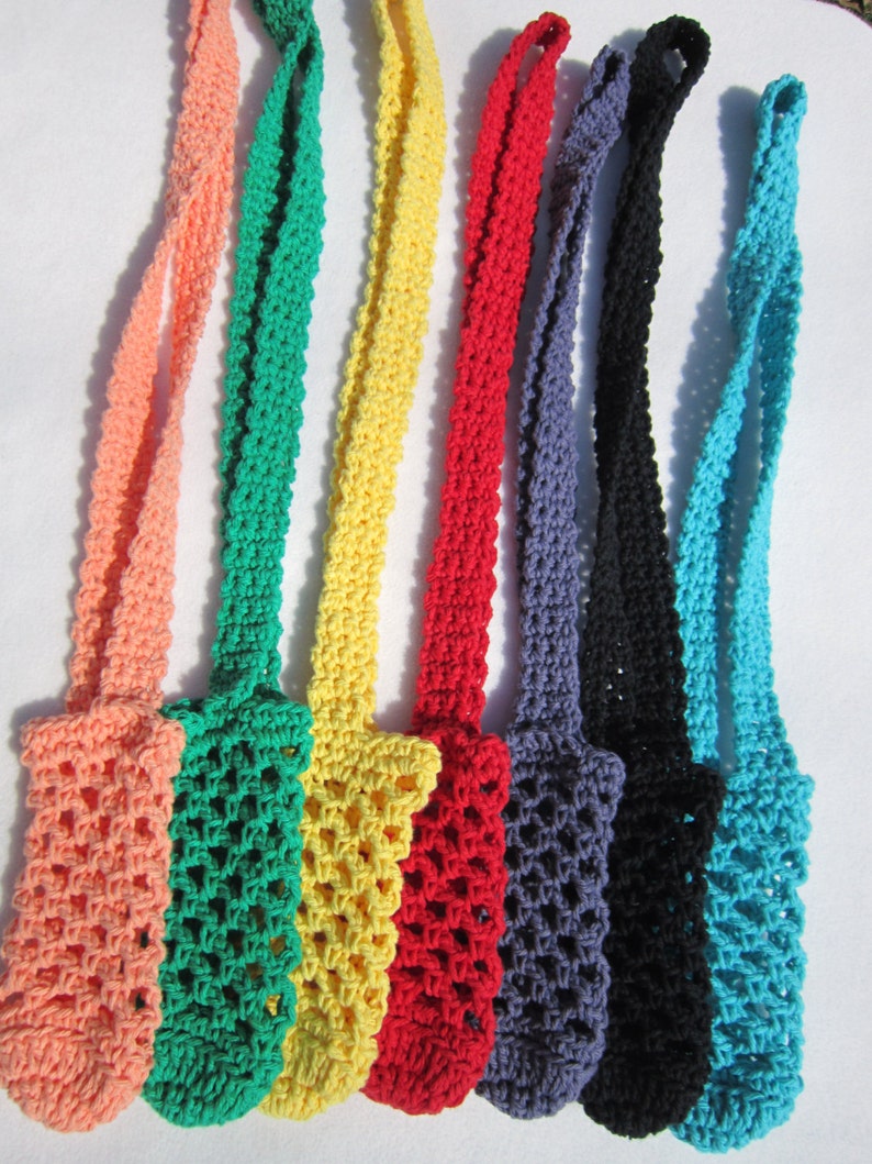 May include: Seven crocheted bottle holders in various colors, including peach, green, yellow, red, purple, black, and blue. The holders are made with a simple, open-weave pattern.