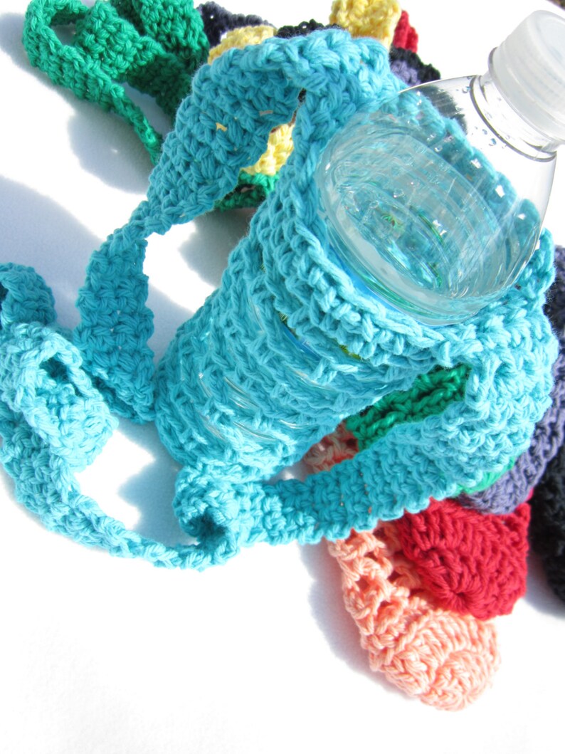 May include: A crocheted water bottle holder with a turquoise strap and a variety of colorful crocheted accents. The holder is designed to fit a standard-sized water bottle.