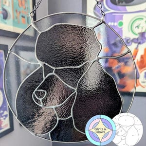 Könnte beinhalten: Runde Glasmalerei mit einem Hundegesicht in Schwarz und Grau. Das Glas ist mit silberfarbenem Metall unterteilt. Es hängt an einer Kette. Der Text "commercial license pattern" befindet sich unten. Der Durchmesser beträgt ca. 20 cm.