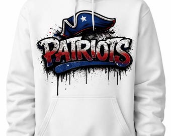 May include: White hoodie with a graffiti-style "PATRIOTS" design in red, white, and blue, including a Revolutionary War hat and star. The sweatshirt has a front pocket. The design has black paint splatters.