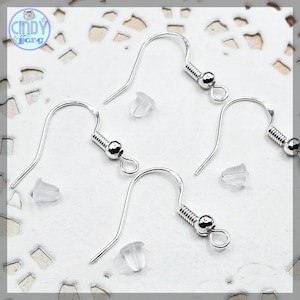 May include: Three silver earring hooks with a spring-loaded closure and a small loop at the end. Four clear plastic earring backs are also included.
