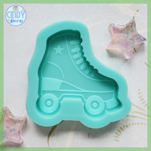 May include: A teal blue silicone mold shaped like a roller skate with a star on the side. The mold is for making resin crafts.