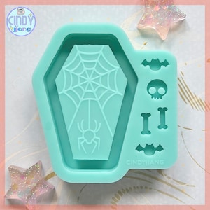 May include: A teal silicone mold featuring a coffin shape with a spider web and spider design. Additional shapes include a skull, bones, and bats. The brand name "CINDYJIANG" is visible.