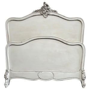 May include: White painted wooden headboard with ornate carvings and a curved design. The headboard is a traditional style with a classic look.