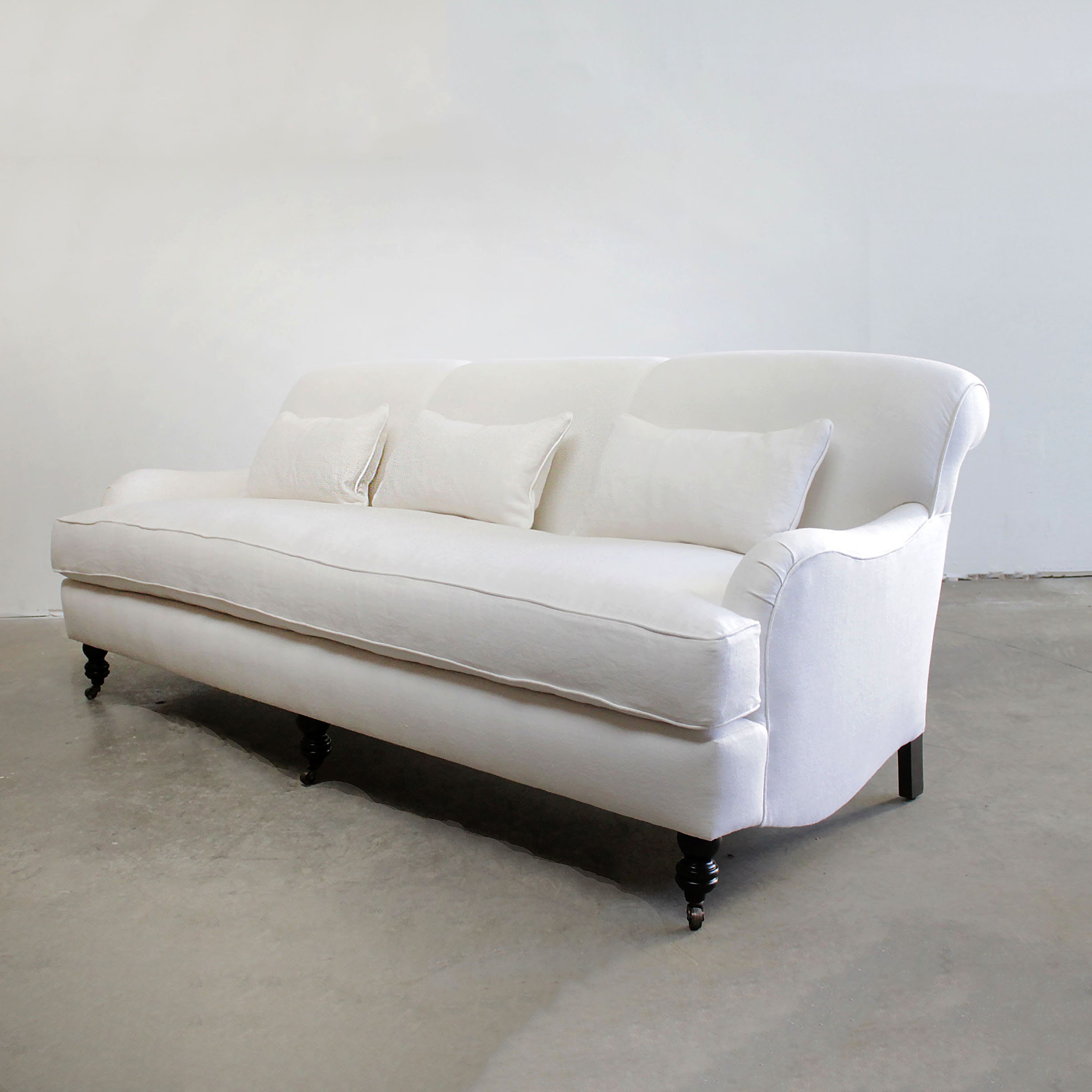 White rolled outlet arm sofa
