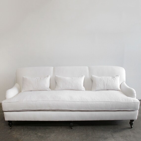 White rolled outlet arm sofa