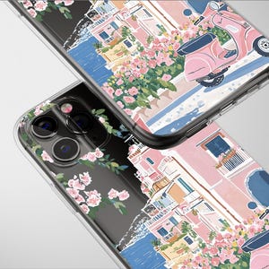 以下が含まれることがあります： ピンクのスクーター、ピンクの建物、花をあしらった水彩デザインの透明な携帯電話ケース。デザインは、青い水と明るい灰色の背景を持つ、海岸をテーマにしています。
