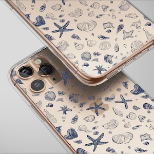May include: Two clear phone cases with a beige background and a pattern of blue seashells and starfish. The cases are slightly overlapping, showcasing the design. The phone cases have a gold-coloured frame.
