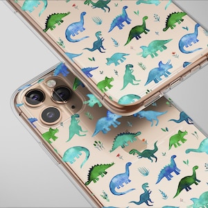 May include: Two clear phone cases with a repeating pattern of watercolor dinosaurs in shades of green and blue on a beige background. The cases are angled, showcasing the design and the phone's camera.