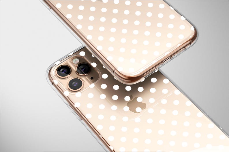 May include: A clear phone case with a white polka dot pattern. The case is designed for an iPhone with a triple lens camera system.
