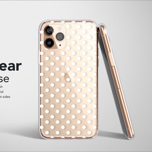 May include: A clear phone case with a white polka dot pattern. The case has a matte finish and is made of soft material. The sides of the case are transparent.