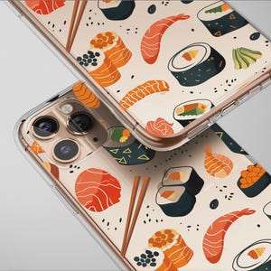 May include: Two clear phone cases with a sushi pattern. The design includes illustrations of sushi rolls, shrimp, salmon, and chopsticks on a cream-colored background. The cases are angled, showcasing the phone's camera.