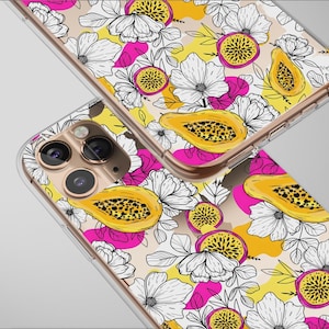 May include: Two clear phone cases with a vibrant floral and fruit design. The pattern includes white flowers, yellow papaya, and pink accents on a beige background. The cases have a gold-colored frame.