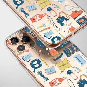 May include: Two clear phone cases featuring a camping design. The pattern includes illustrations of a lantern, binoculars, a campfire, a frying pan with eggs, a backpack, and a fishing rod. The cases are on a light grey background.