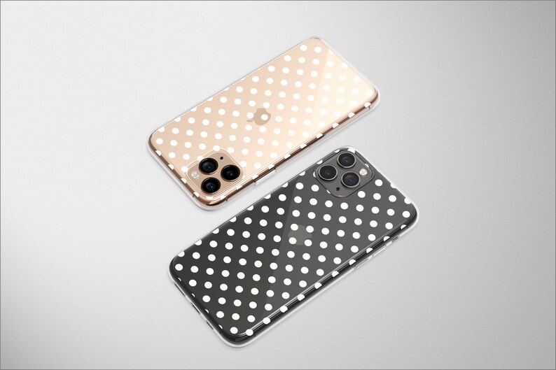 May include: Two clear phone cases with white polka dot patterns. One case is gold and the other is black.