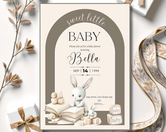May include: A baby shower invitation with a neutral color palette. The invitation features the text "sweet little BABY" and "Bella" in elegant script. A watercolor illustration of a bunny and blocks is included. The date and time are also displayed.