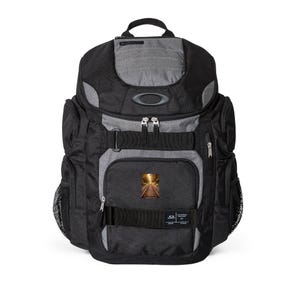May include: Black and grey backpack with multiple compartments and a top handle. Features a small image of a railway track on the front pocket. Includes the Oakley logo and multiple zippers and straps.