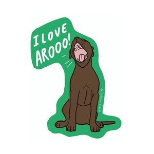 May include: A green sticker with a brown dog sitting and howling. The dog has a pink tongue sticking out. The sticker says "I love AROOO!" in white text.