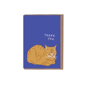 May include: A greeting card with a blue background and a drawing of an orange cat. The words "THANK YOU" are written in white. The card has a brown border.