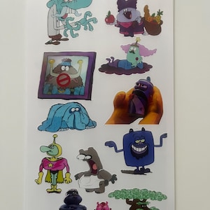 May include: A sheet of colorful cartoon character stickers. The stickers feature various characters in different poses and outfits. The characters are in shades of blue, purple, pink, and brown. Some stickers have a white border.