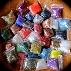 May include: Assortment of colorful iridescent craft fibers in individual clear plastic bags. The fibers are packaged in a wooden bowl.