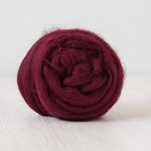 May include: A ball of deep burgundy wool roving, perfect for felting projects.