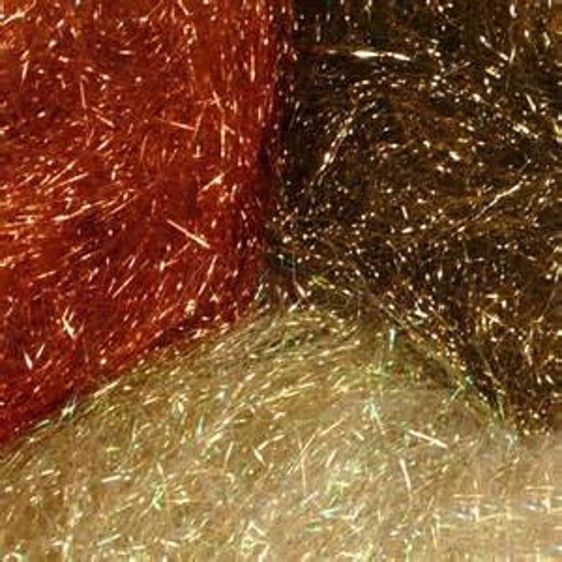 May include: Three spools of iridescent fly tying material in copper, gold, and green.