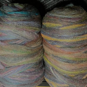 May include: Four balls of colorful wool yarn, each with a different blend of colors, including shades of brown, blue, green, and yellow.
