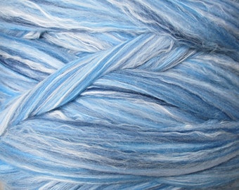 May include: A close-up of a skein of blue and white yarn. The yarn is soft and fluffy, and it has a subtle shimmer.