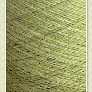 May include: A close-up of a skein of light green yarn. The yarn is made of natural fibers and has a soft, textured appearance.