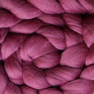 May include: Close-up of a deep burgundy braided yarn. The yarn is soft and fluffy, with a slightly textured surface.