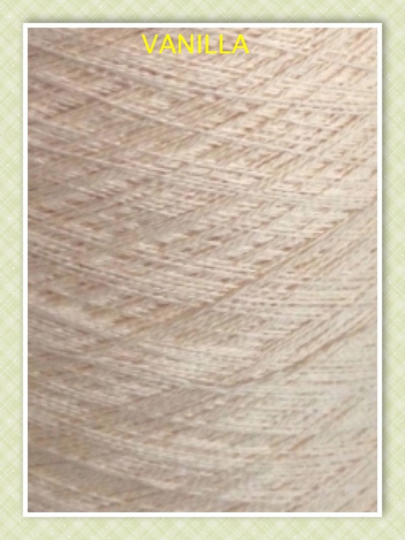 May include: Close-up of a skein of yarn in a light beige color, labeled "VANILLA". The yarn has a textured, slightly bumpy surface.