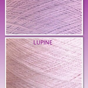 May include: Two skeins of yarn, one labeled "LAVENDER" and the other "LUPINE". Both skeins are a light purple color.