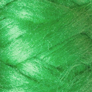 May include: Close-up of bright green fiber material. The fibers have a slightly shiny appearance and are tightly packed together, creating a textured surface. The color is a vibrant, saturated green.