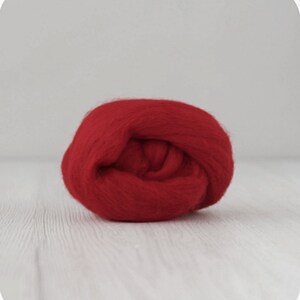 May include: A ball of bright red wool roving, perfect for felting projects.