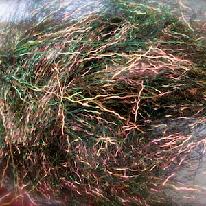 May include: A close-up of a bundle of iridescent fly tying material. The material is a mix of black, green, and pink fibers with a holographic sheen.