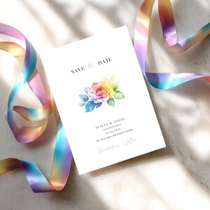 May include: A white rectangular save the date card featuring a central watercolor rainbow rose illustration with green leaves. The text reads SAVE THE DATE, OLIVIA & ANGEL ARE GETTING MARRIED, 30.06.2025, The Rose Lane, 456 Flower Garden, Invitation to follow.