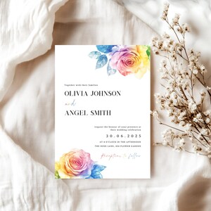 May include: A rectangular wedding invitation card featuring watercolor rainbow-colored roses at the top and bottom corners. The text reads: Together with their families, OLIVIA JOHNSON and ANGEL SMITH, request the honour of your presence at their wedding celebration, 30.06.2025, at 4 o'clock in the afternoon, The Rose Lane, 456 Flower Garden, Reception to follow.