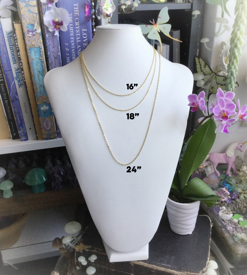 May include: Three gold chains of different lengths, 16 inches, 18 inches, and 24 inches, displayed on a white mannequin bust.