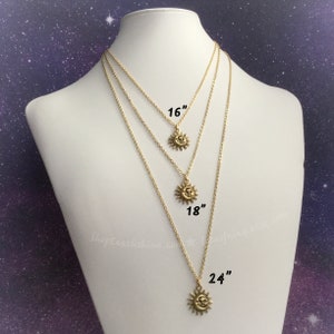 May include: Three gold necklaces with a sun pendant on each. The necklaces are 16 inches, 18 inches, and 24 inches long.