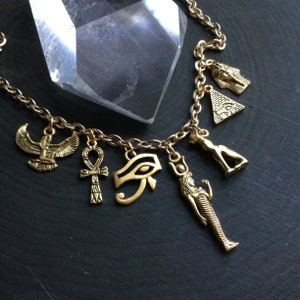 Gold Egyptian necklace, Eye of Ra, Winged Goddess, Pyramid, Bastet, 24k plated charm necklace